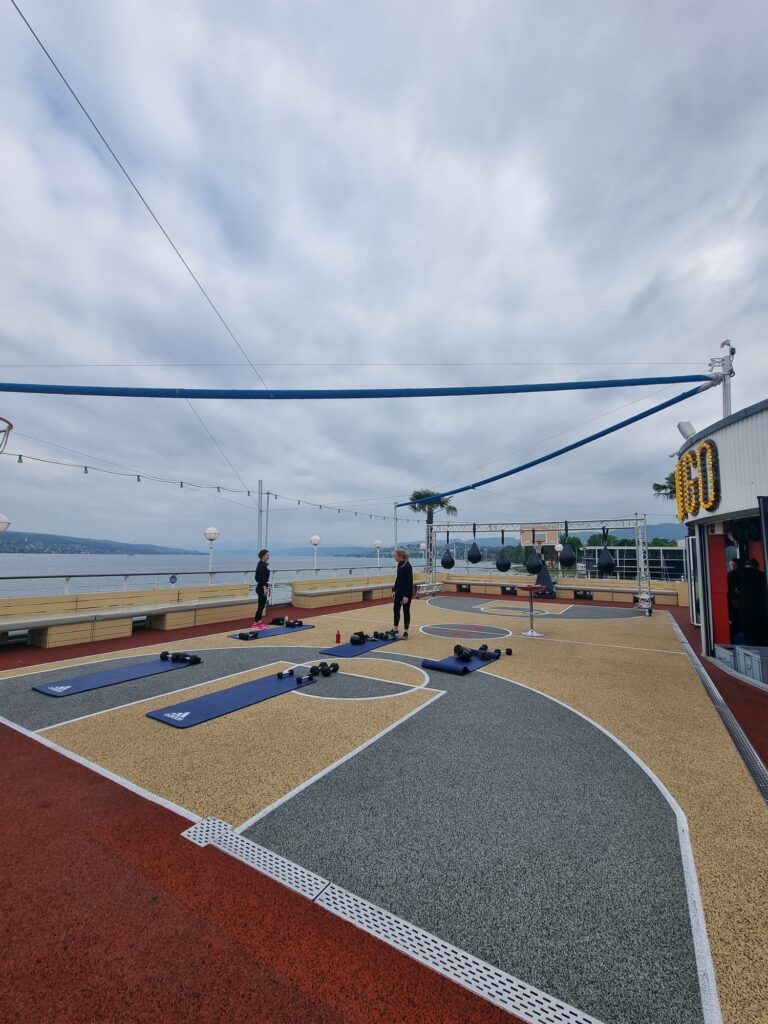 Outdoor fitness area with two women by the lake